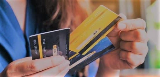 Person holding credit cards